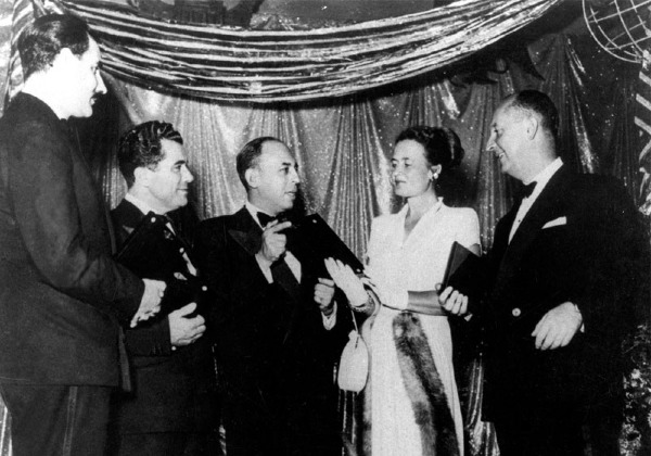 1947 black and white photo of Stanley Marcus standing with four fashion designers