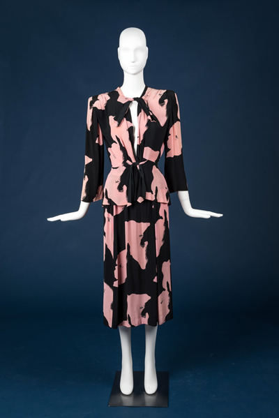 Holstein suit by Adrian, ca. 1935, coral and black on a mannequin