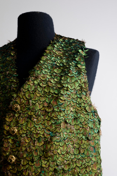 Green iridescent feather vest on a mannequin